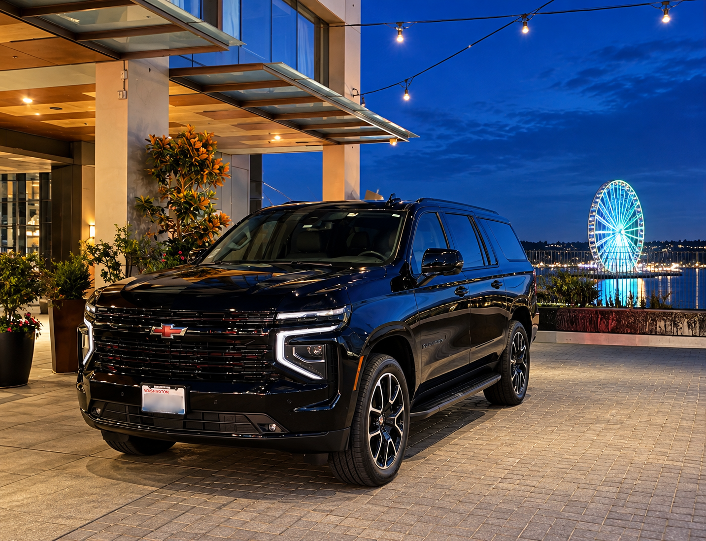 Black Chevrolet Suburban at the Seattle waterfront with the illuminated Great Wheel at night