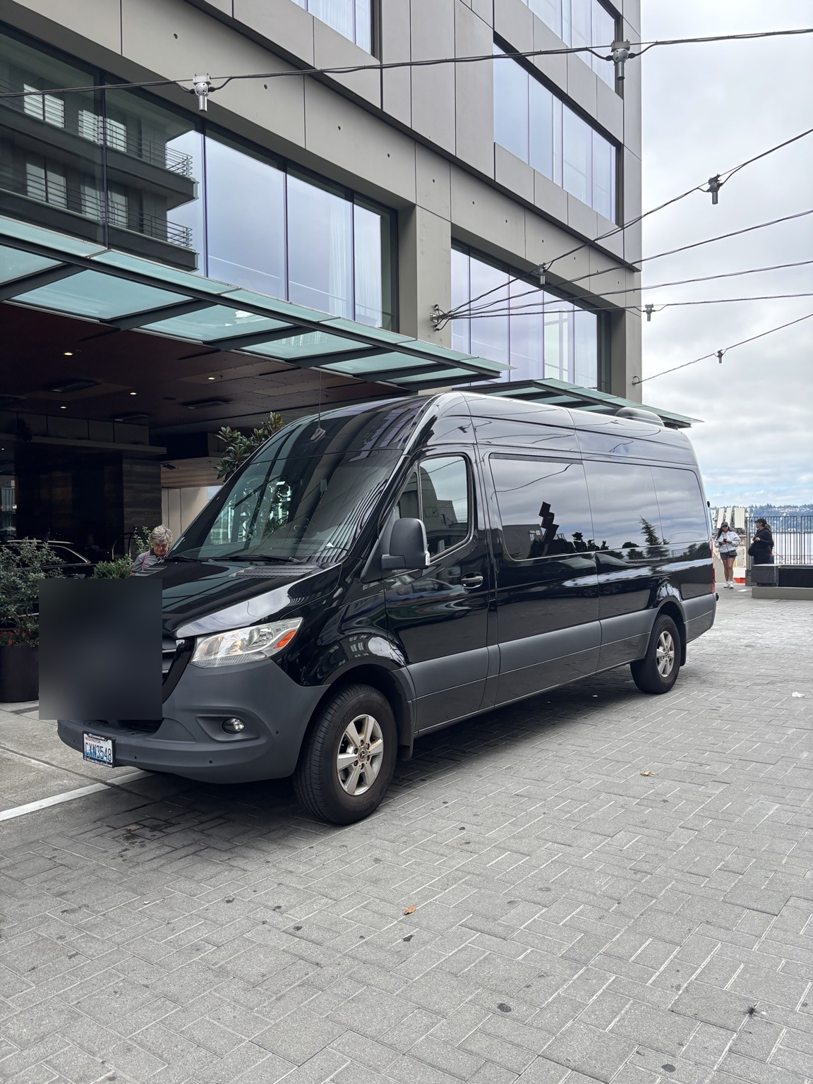 Black Mercedes-Benz Sprinter at downtown hotel