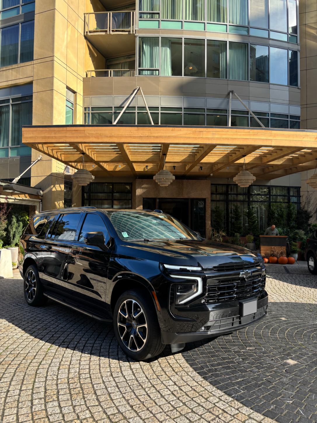 Black Chevrolet Suburban at a covered city entrance